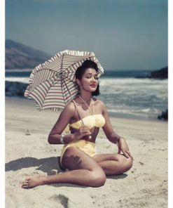 "WOMAN ON BEACH HOLDING UMBRELLA" FROM GETTY IMAGES